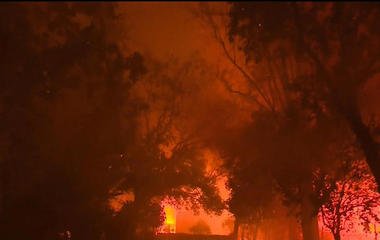 Woman dies while seeking refuge from wildfire in pool